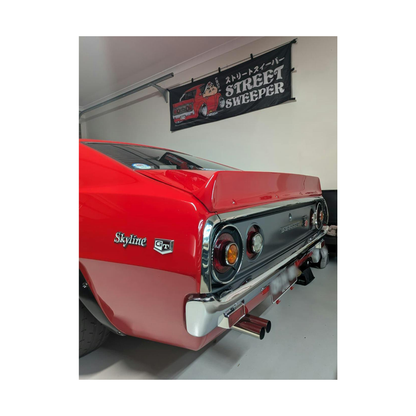 Street Sweeper Nobori flag displayed in a garage featuring red Kenmeri C110 Skyline artwork, Crayon Shin Chan inspired character and Japanese text
